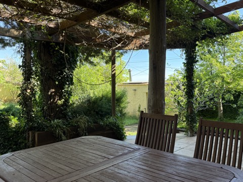 Outdoor dining table under the leafy pergola – The Barn, Costa Brava